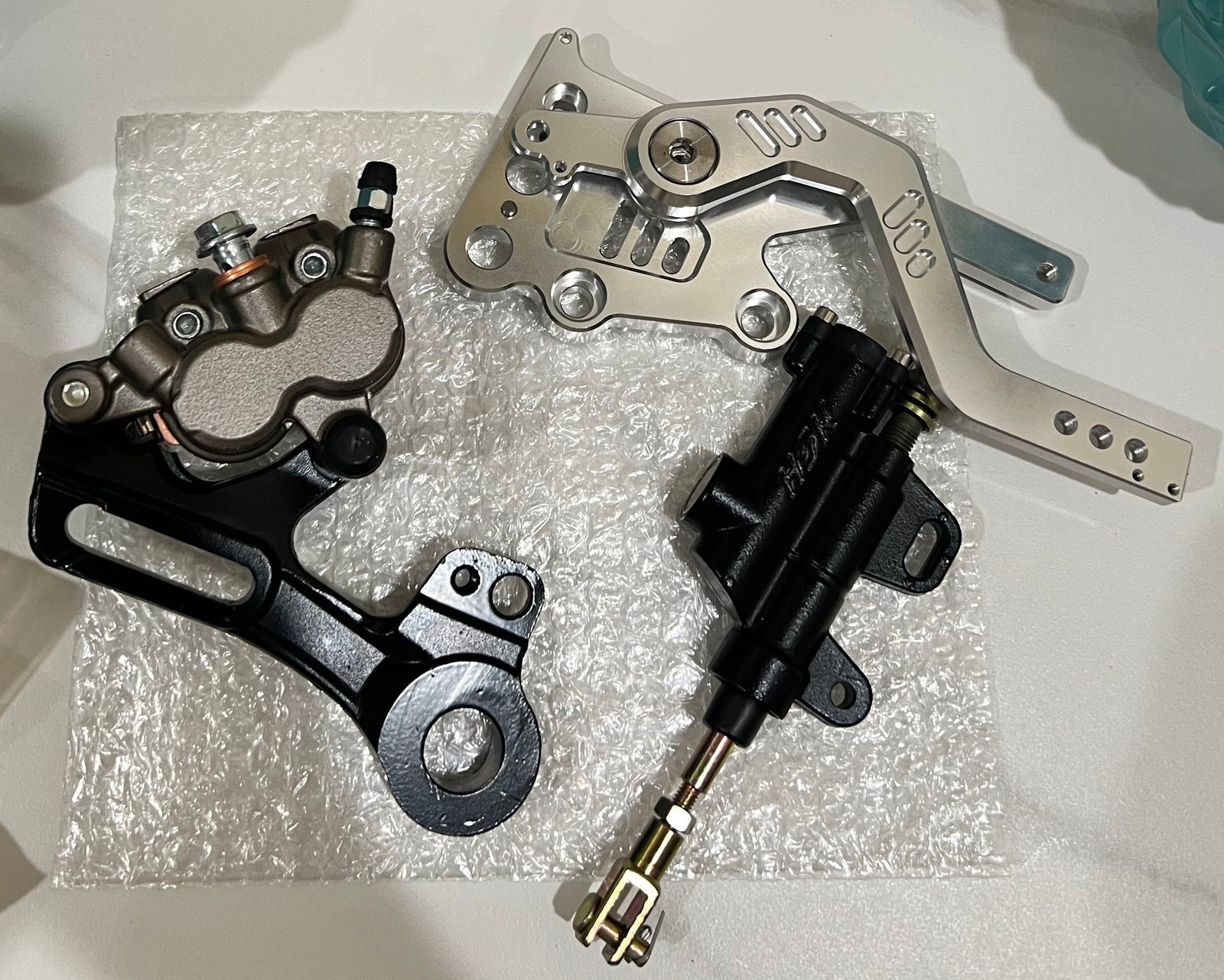 Silver Surron Ultra Bee V2 footbrake front view